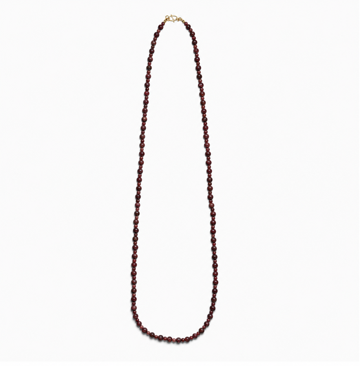 Lea Garnet necklace, a long single strand of deep red natural stone beads with a gold-plated clasp