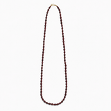 Lea Garnet necklace, a long single strand of deep red natural stone beads with a gold-plated clasp