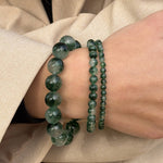Essential Green Moss Agate bracelet in a stack with the Chunky and Petite styles, worn with a beige coat