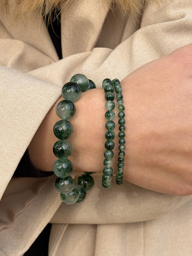 Essential Green Moss Agate bracelet in a stack with the Chunky and Petite styles, worn with a beige coat
