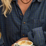 Luna Tiger Eye necklace worn with a blue checked shirt, over a cup of coffee