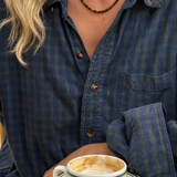 Luna Tiger Eye necklace worn with a blue checked shirt, over a cup of coffee