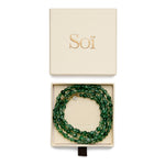 Lea Green Moss Agate necklace coiled in an open Soï gift box with its cream lid