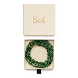 Lea Green Moss Agate necklace coiled in an open Soï gift box with its cream lid